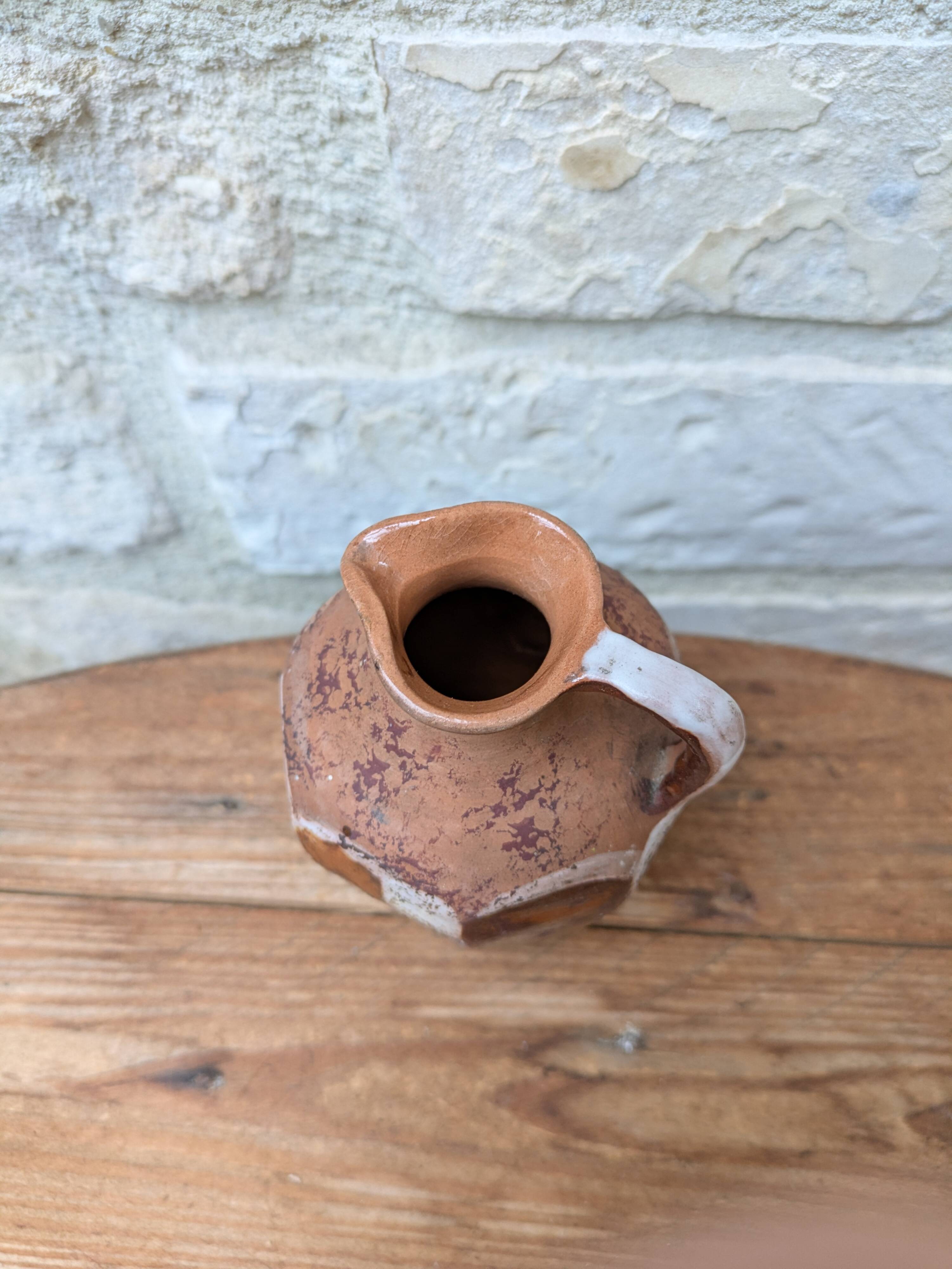 Old small pitcher in glazed terracotta
