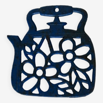Small vintage enameled cast iron trivet in the shape of a blue teapot