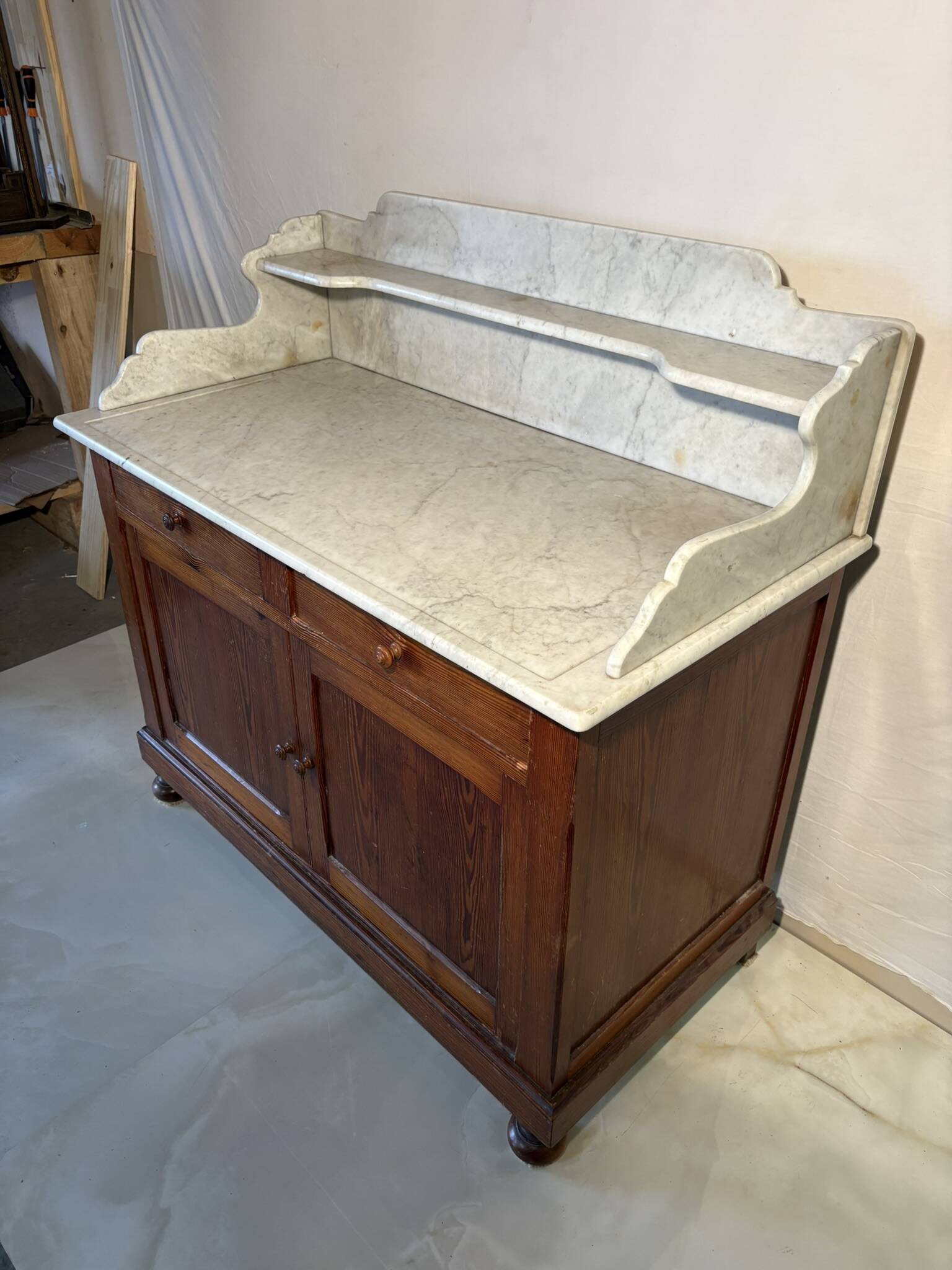 Antique wood and marble kitchen sideboard with carved backsplash