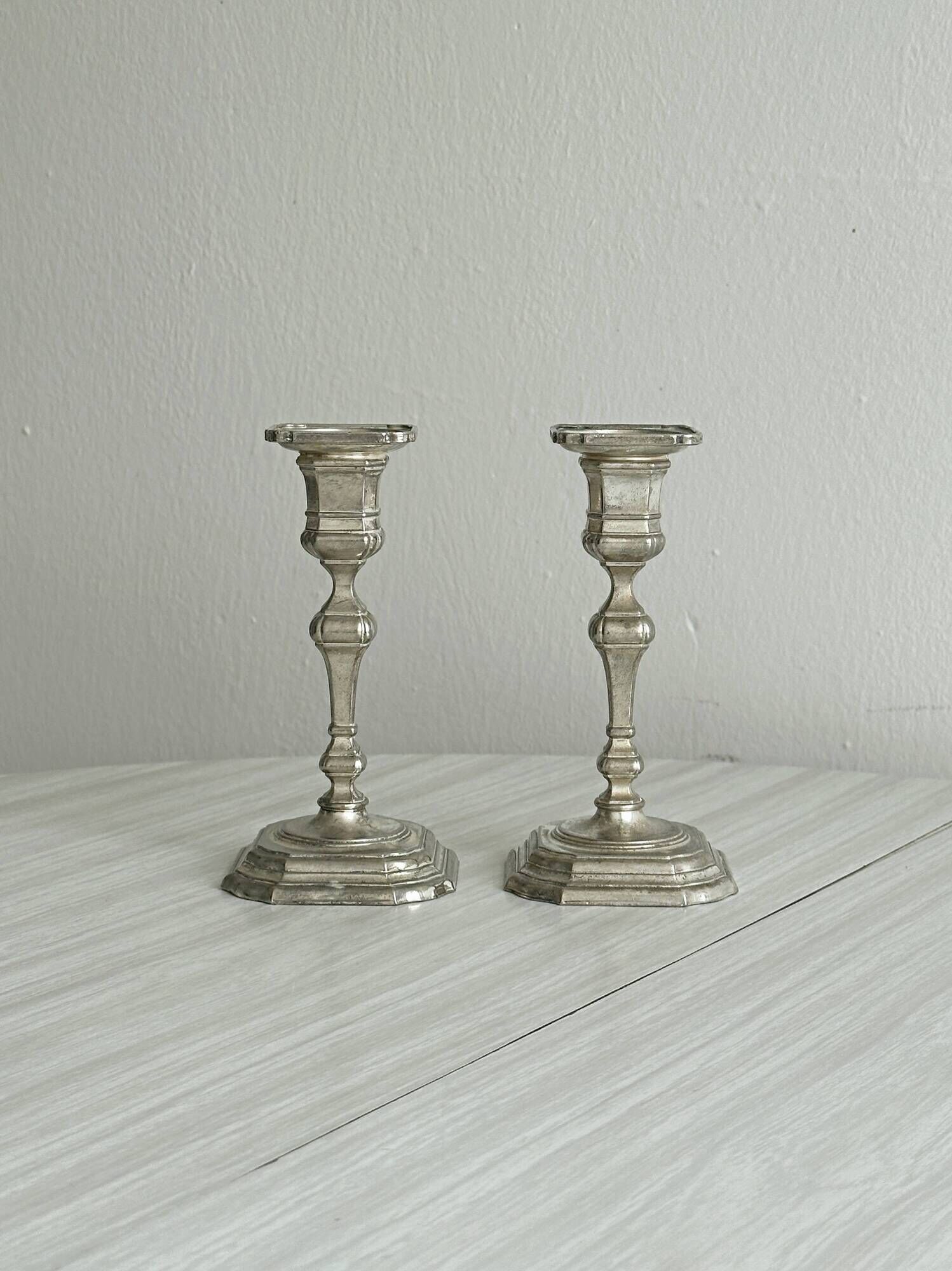 Pair of patinated silver-plated candlesticks