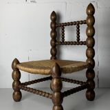 Brutalist wood turned bobbin low rush chair in the style of Charles Dudouyt