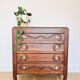 Antique commode with carved relief