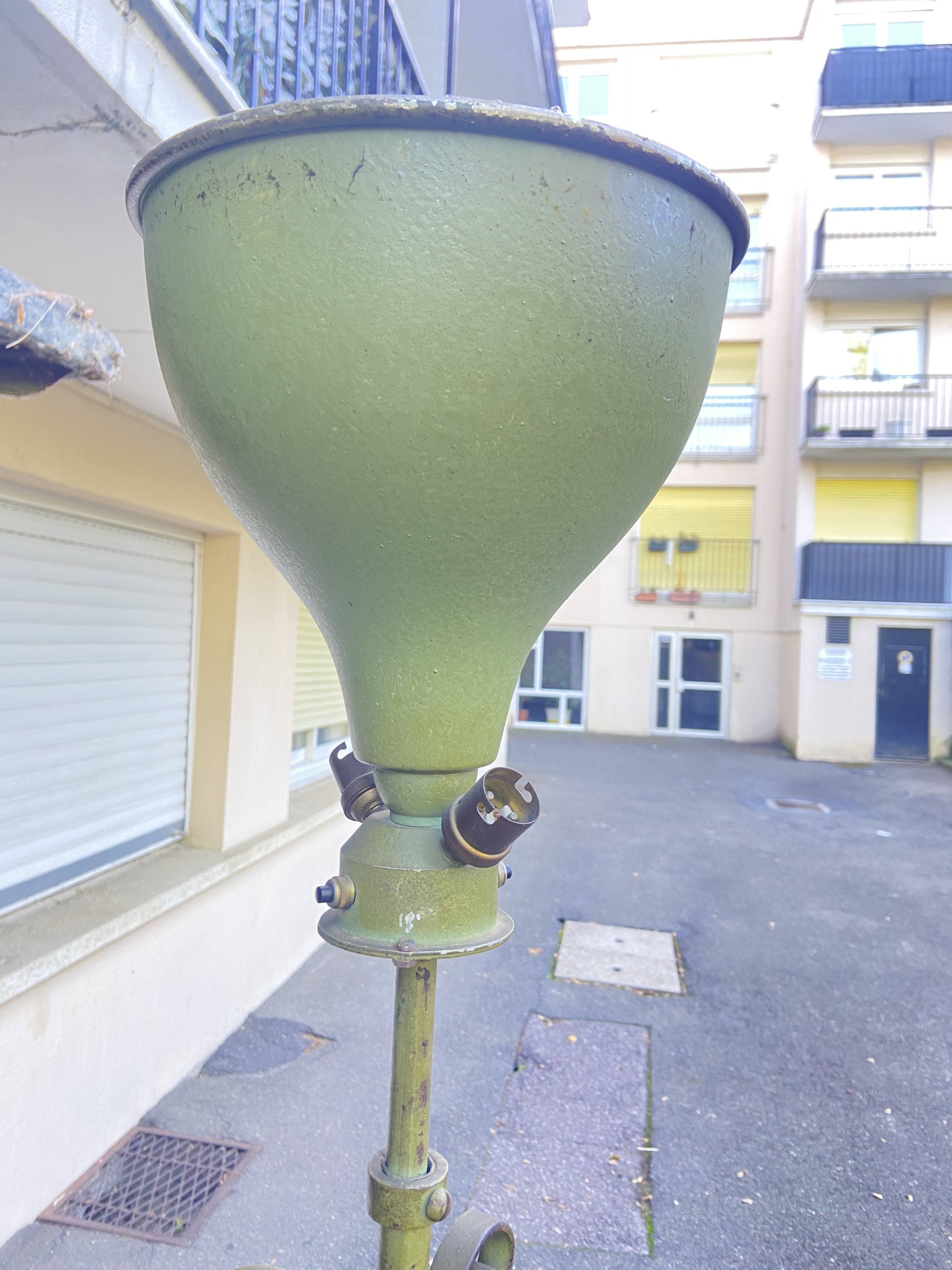 Antique green-painted iron floor lamp with a floral design.