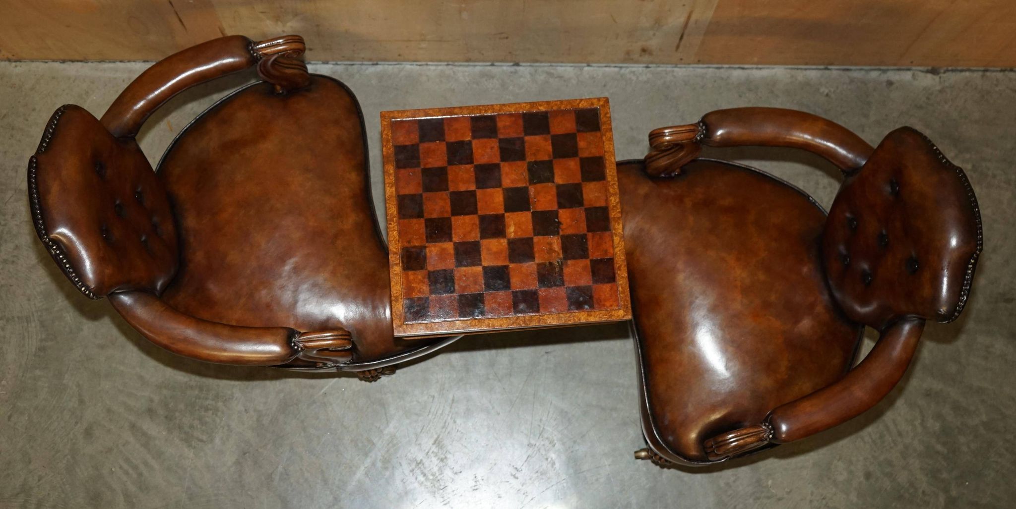 High Victorian leather tête-à-tête canapé with a walnut burr chessboard.