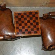 High Victorian leather tête-à-tête canapé with a walnut burr chessboard.