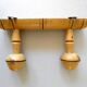 Coat rack with 2 wooden hooks imitating bamboo.