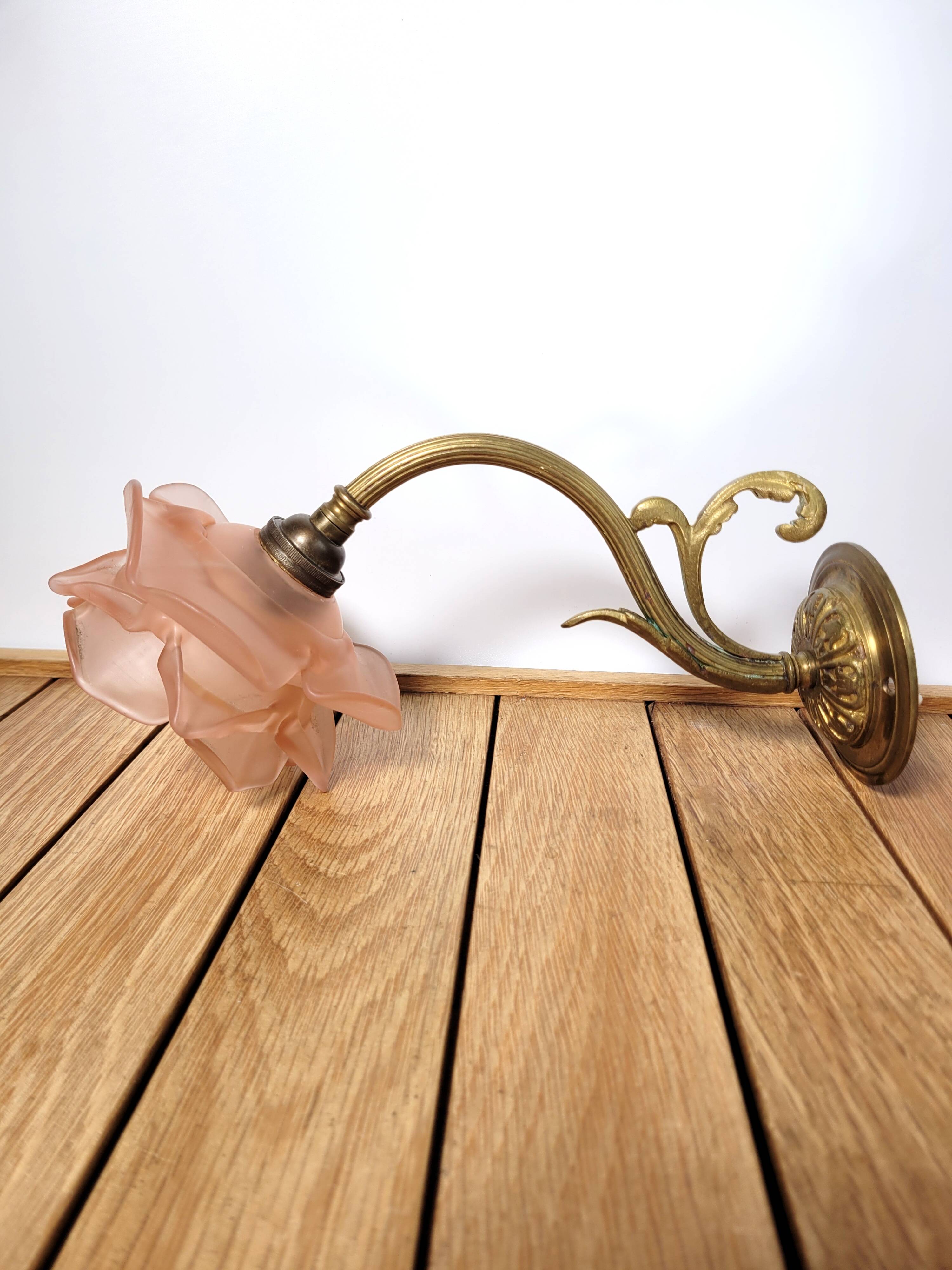 Old pink and golden brass wall lamp