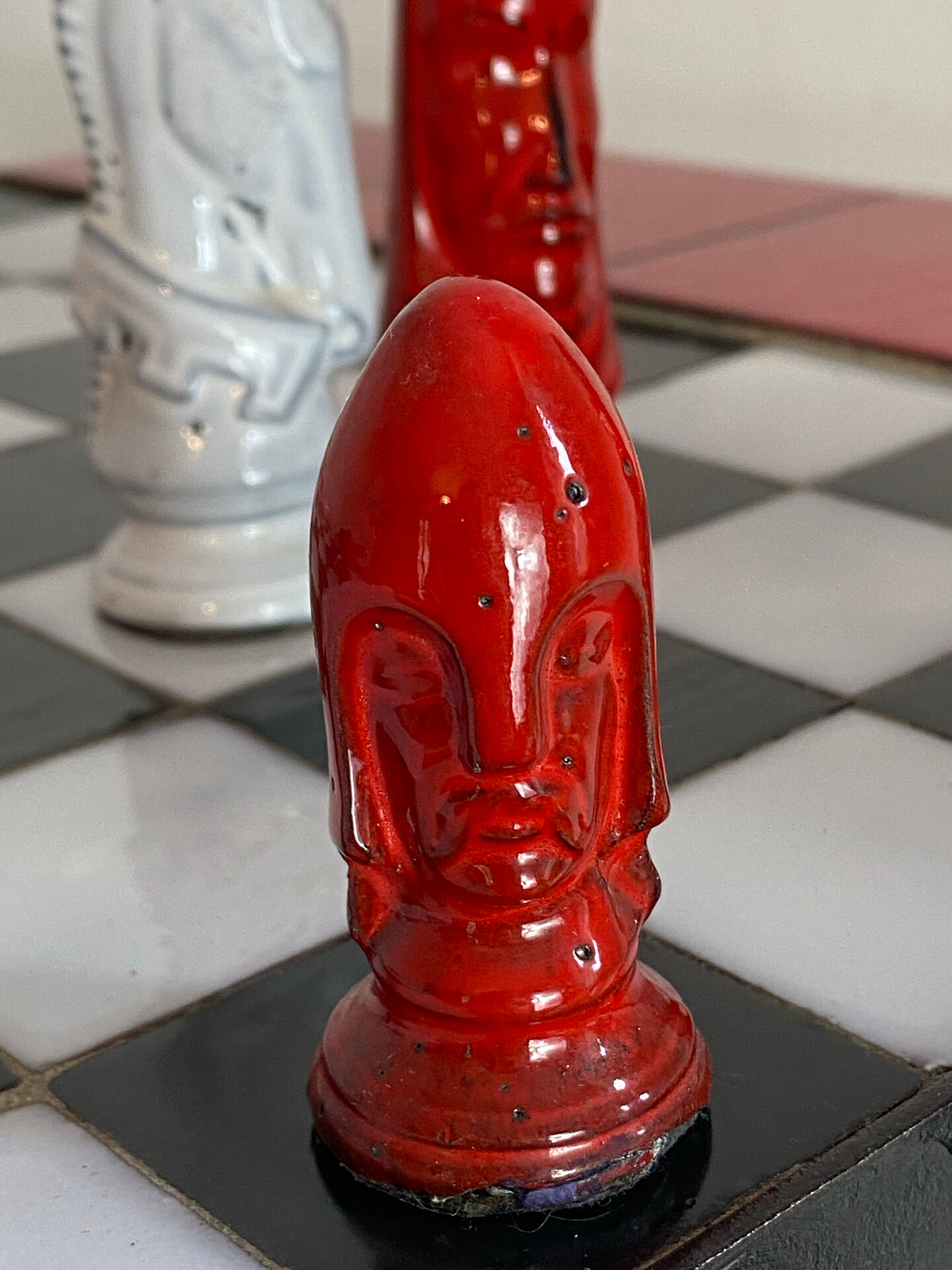 Chess set with ceramic board and pieces.