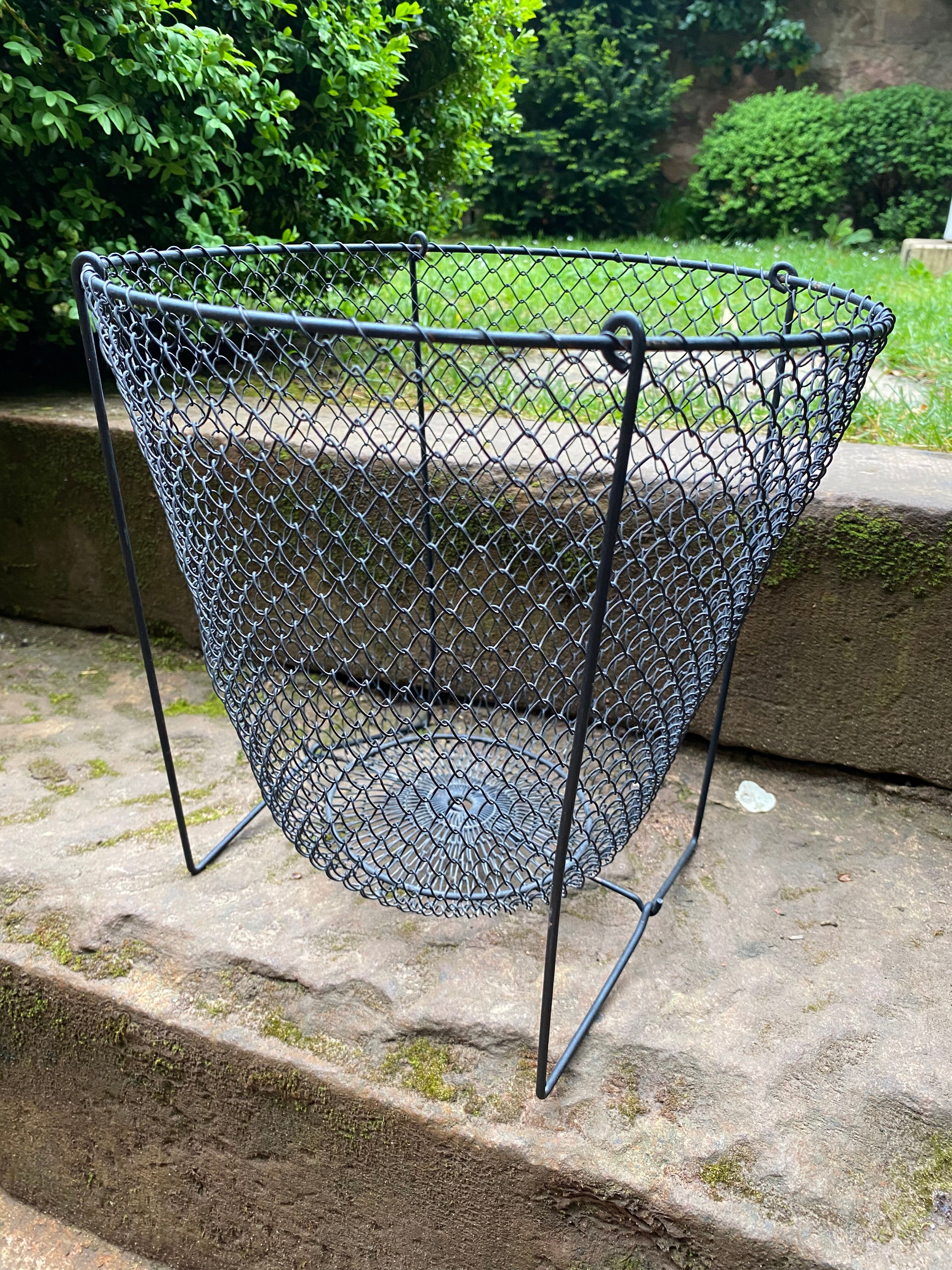 Foldable black woven metal wastepaper basket from around 1950.