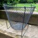 Foldable black woven metal wastepaper basket from around 1950.