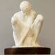 Sculpture of a seated man. Classical male sculpture. Male figure.