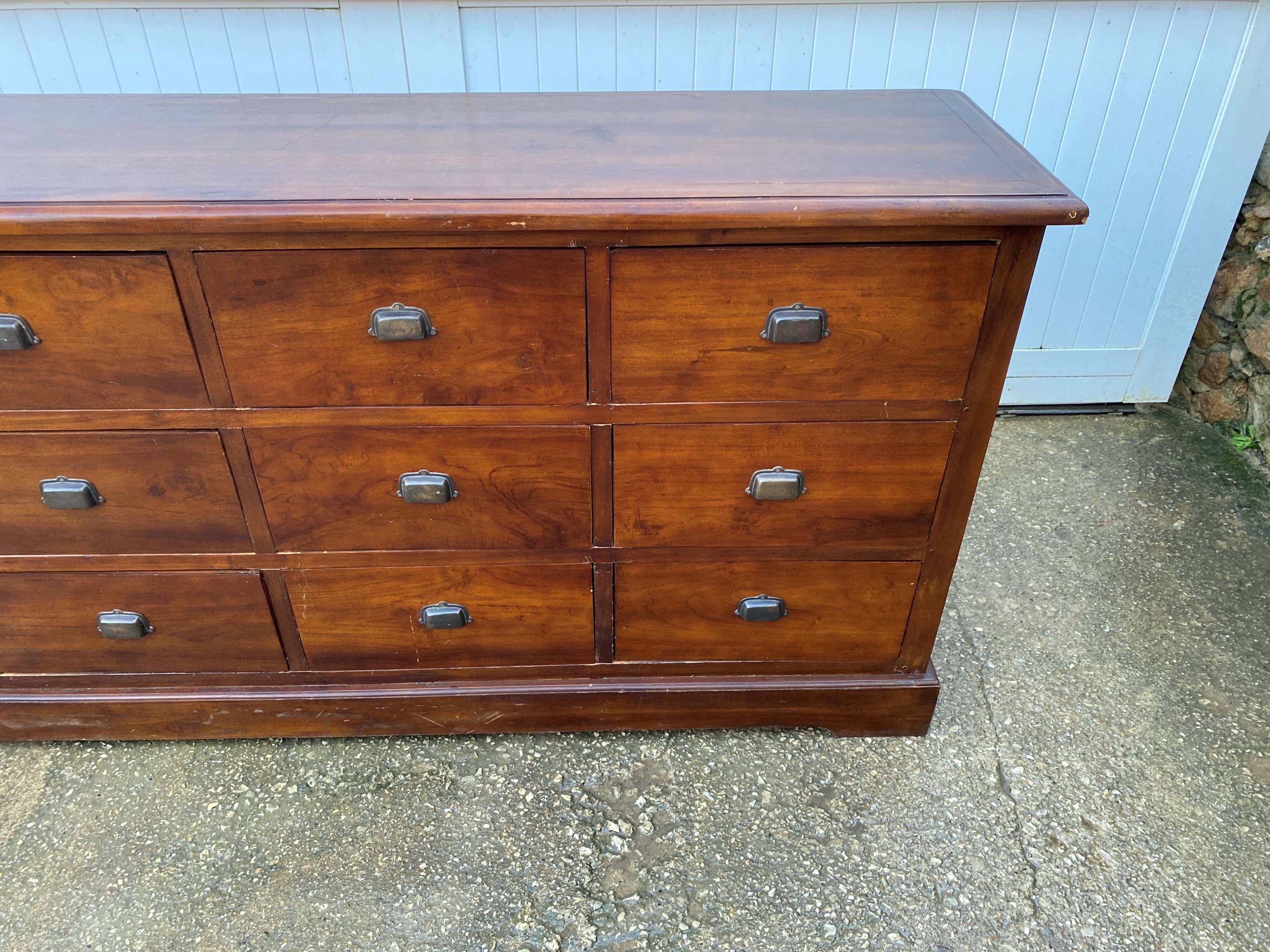 Old and authentic trade storage unit counter with 12 large drawers in cherry wood 1950