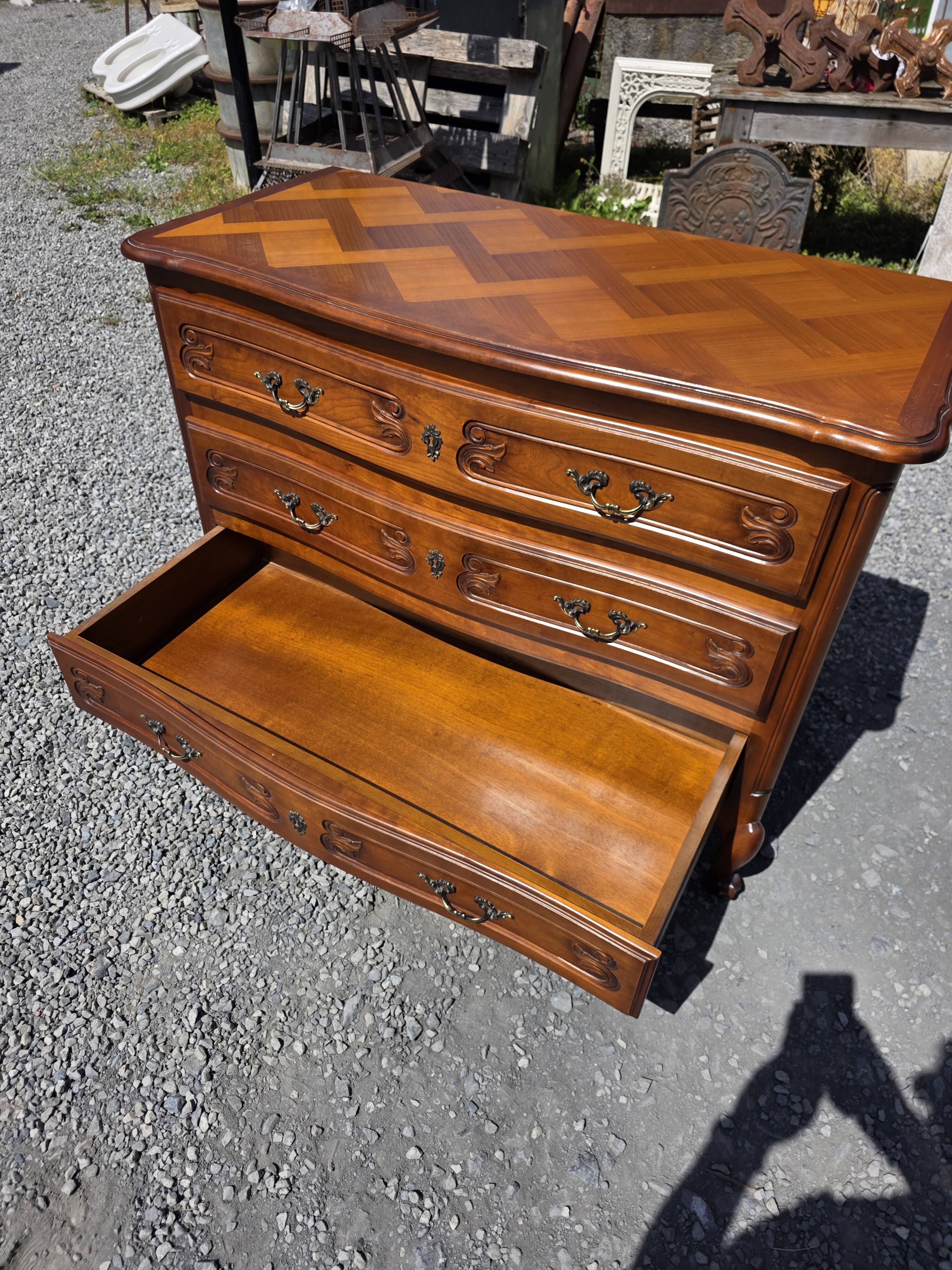 Curved commode in Louis XV style made of cherry wood.