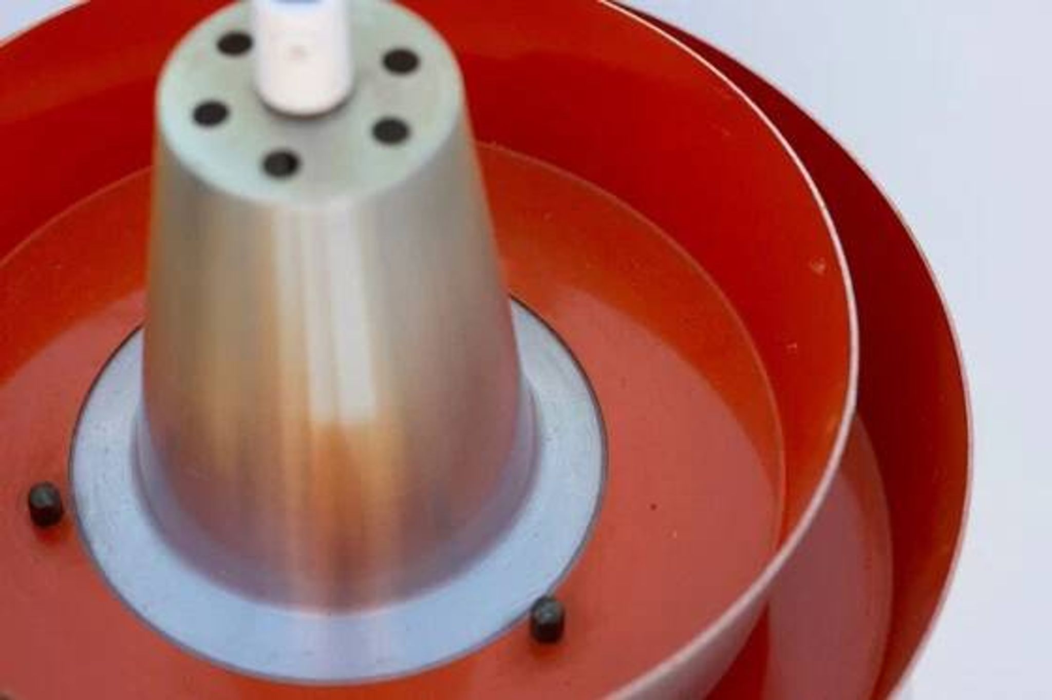 Carl Thore's Trava lamp in aluminium with an orange lacquered interior.