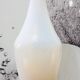 Vintage white opaline soliflore vase with blue reflections and twisted foot.