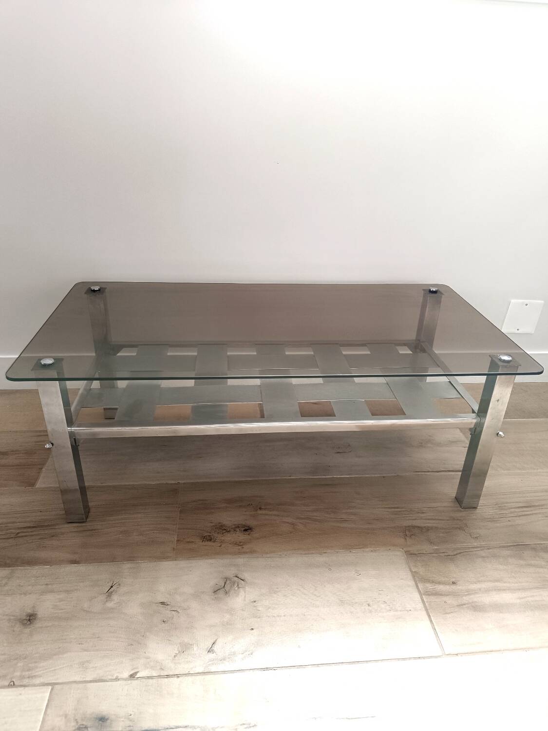 Vintage smoked glass coffee table with chrome legs.