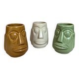 Set of three small Moai-style head vases.