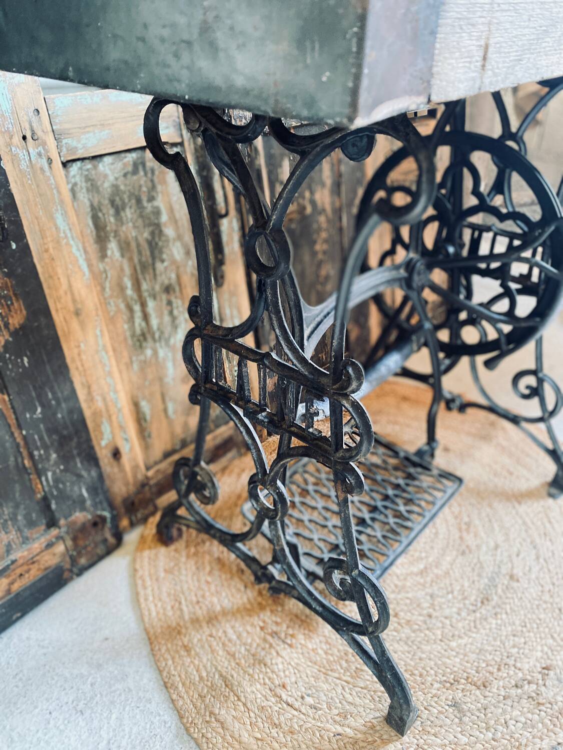 Vintage wooden table with a cast iron base.