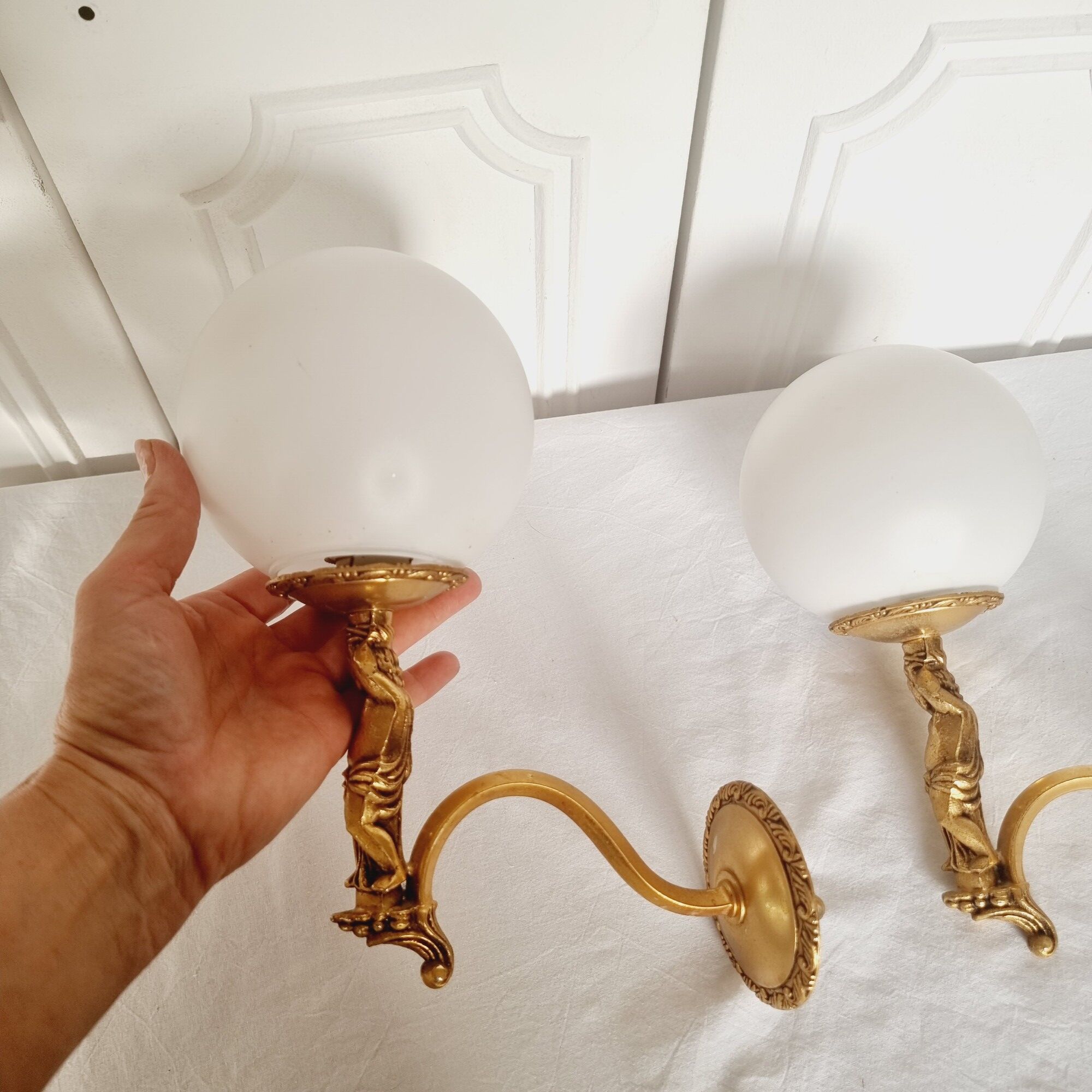 2 classic golden cherub wall lights and globe lampshades in perfect condition.