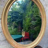 Golden oval mirror