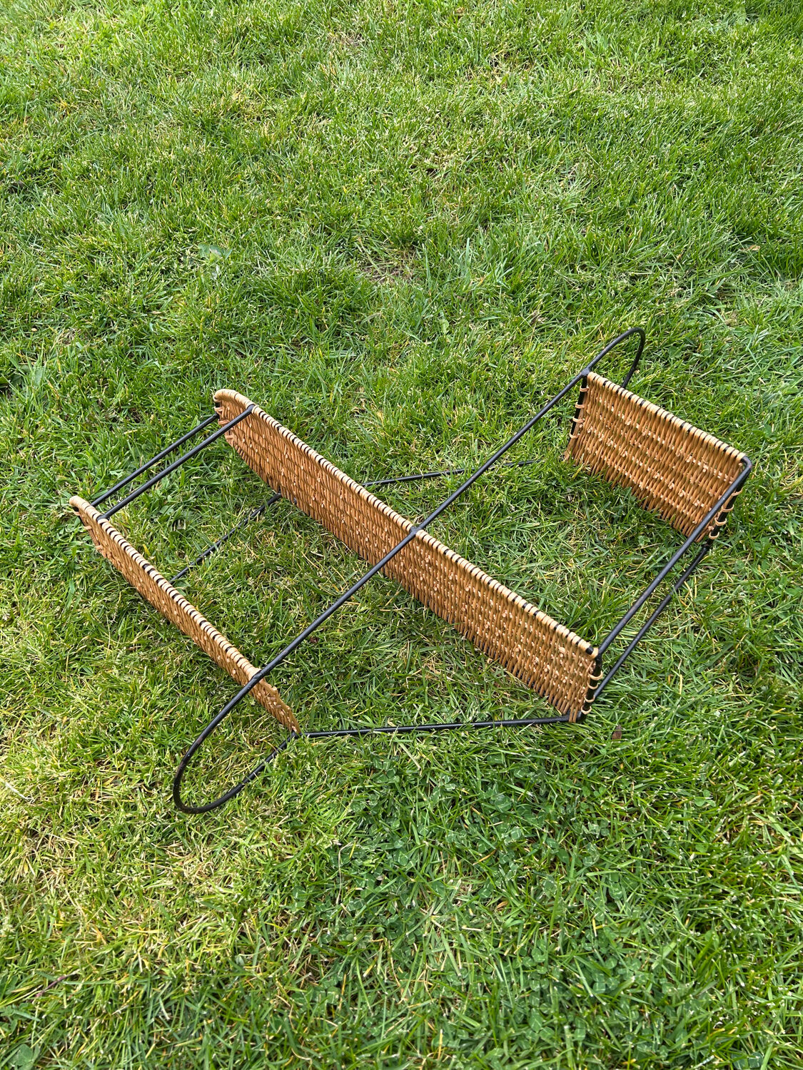 Wall shelf made of rattan and wrought iron
