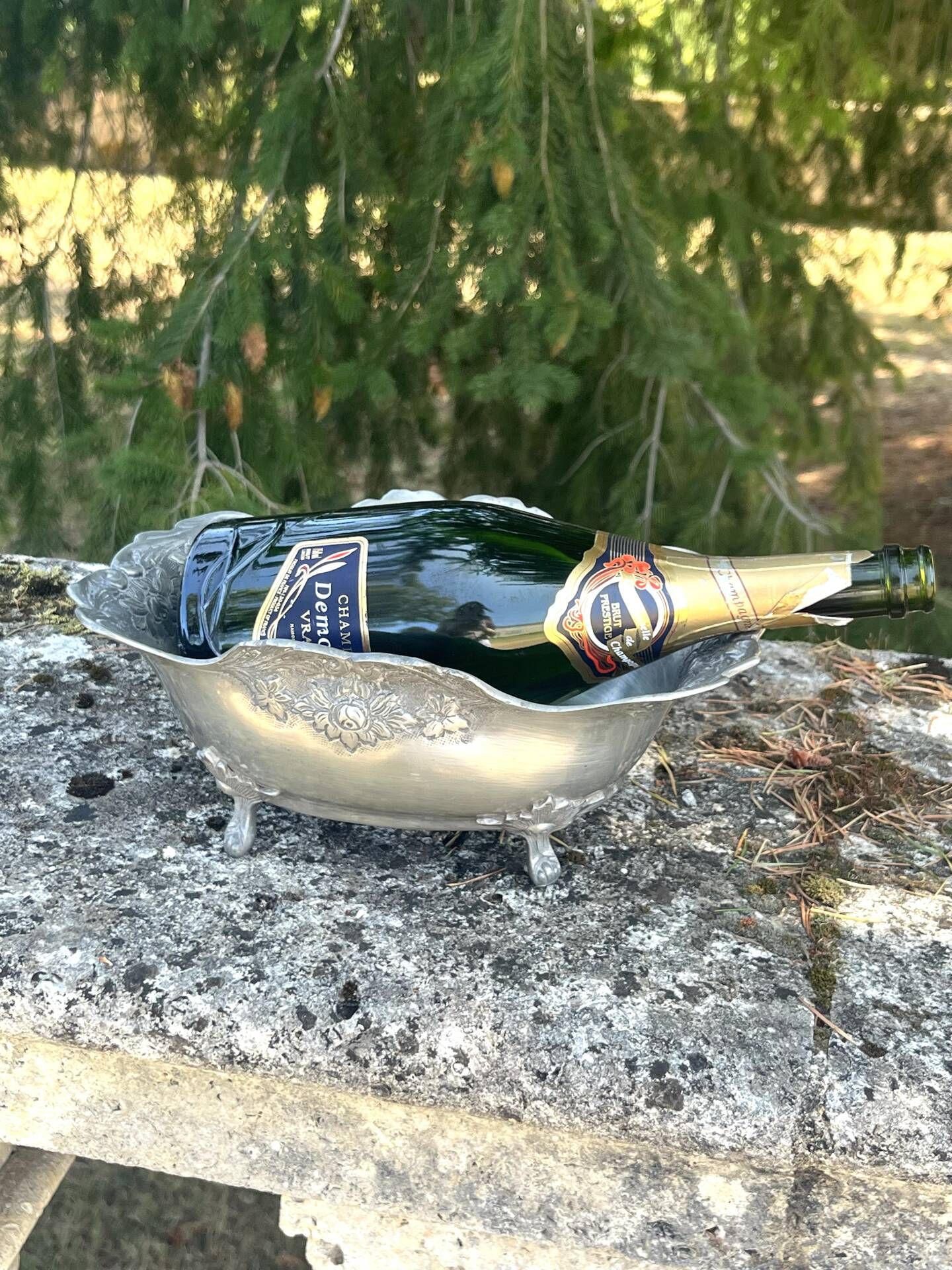 Footed pewter champagne cooler on claw feet with floral relief
