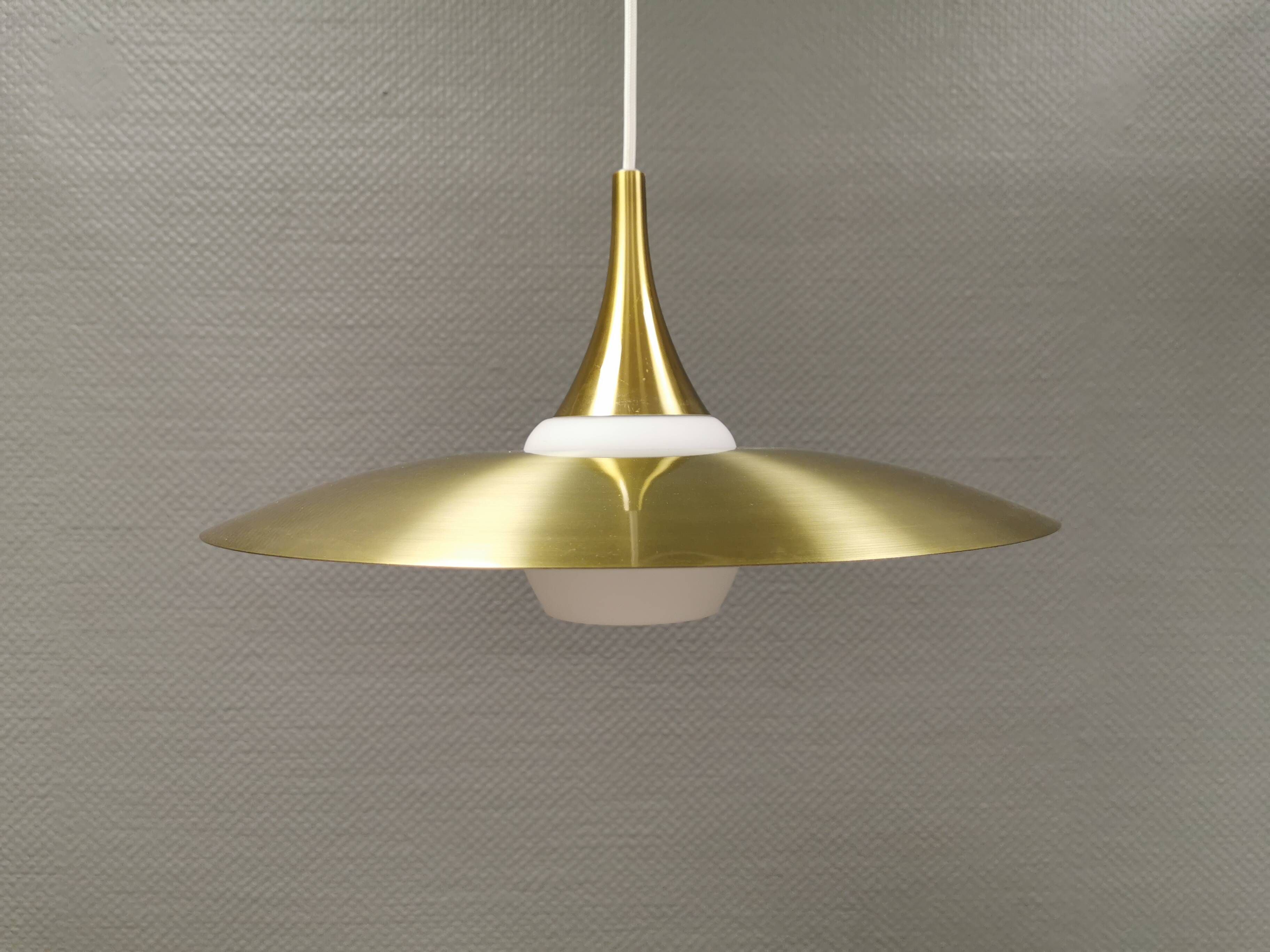 Hanging lamp, from the 1970s in matte white glass and brass colored metal.