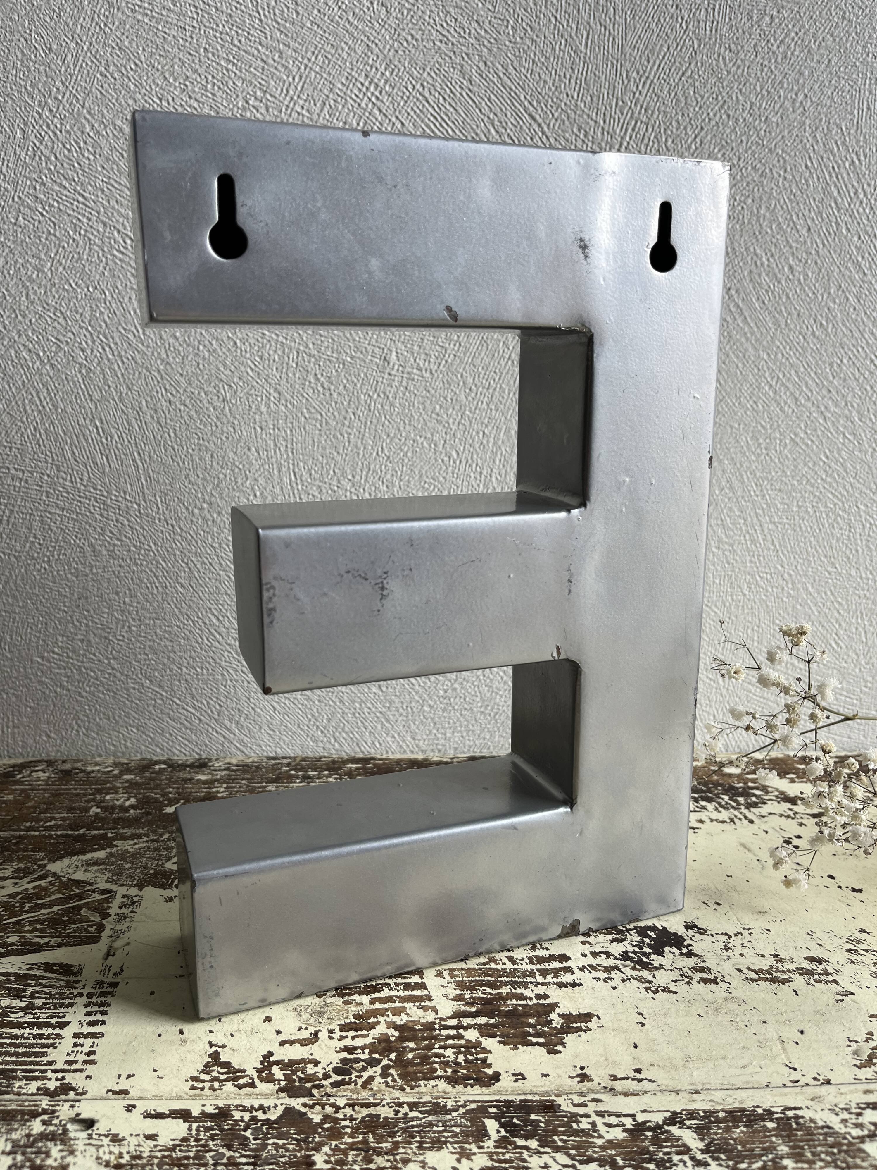 Metal sign letter E