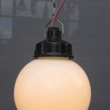 Trio of opal glass and bakelite globe pendant lights