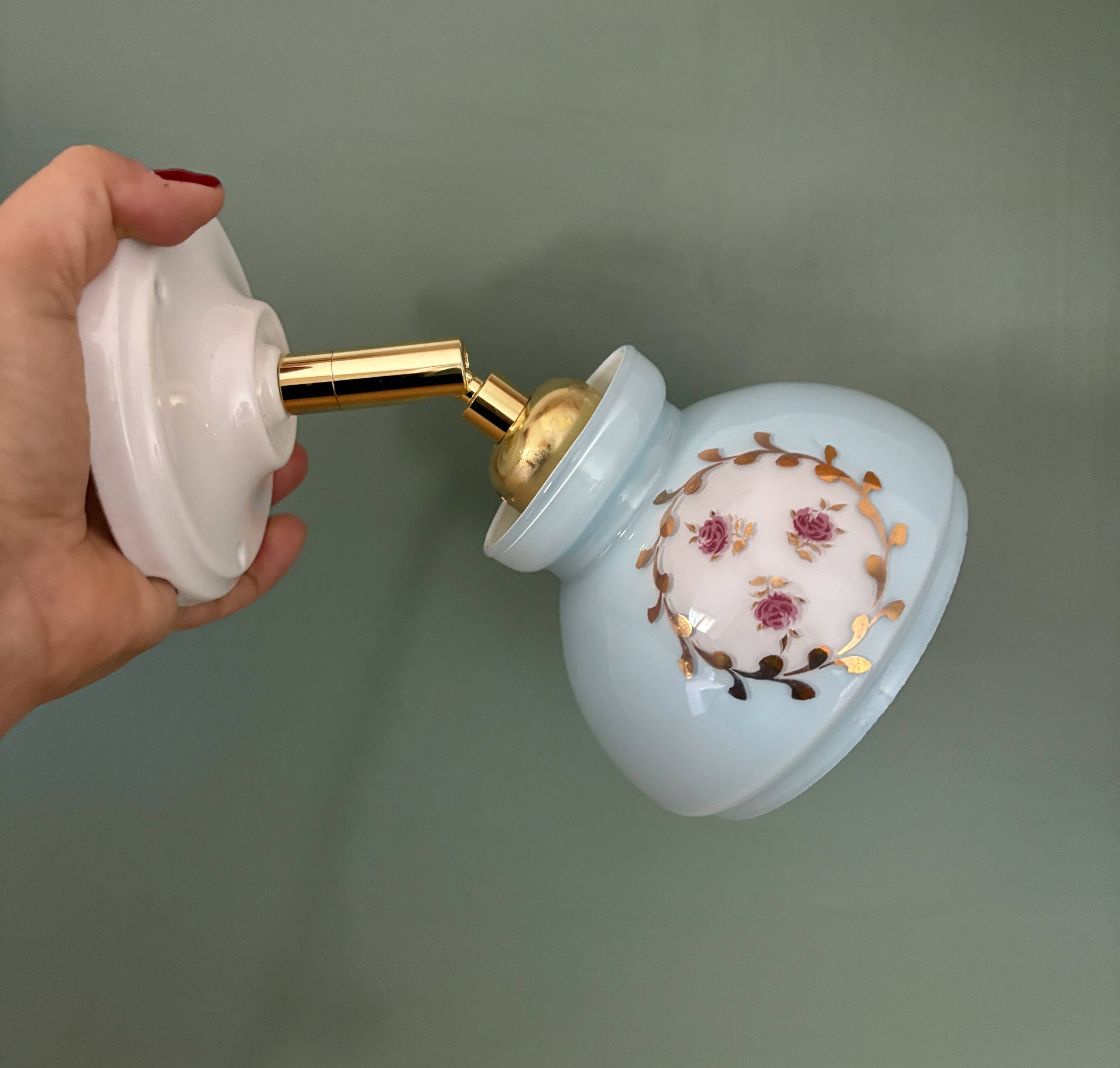 Vintage wall sconce with blue opaline glass shade and floral decorations