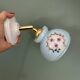 Vintage wall sconce with blue opaline glass shade and floral decorations