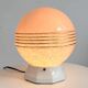 Art Deco lamp with a speckled pink glass globe and a white ceramic base.