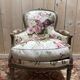 Reupholstered bergère with floral fabric in Louis XVI style.