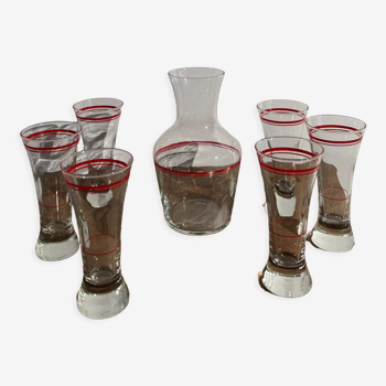 Vintage glass decanter with red edging and its 6 glasses