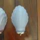 Pair of Art Deco shell wall sconces in frosted glass and brass.
