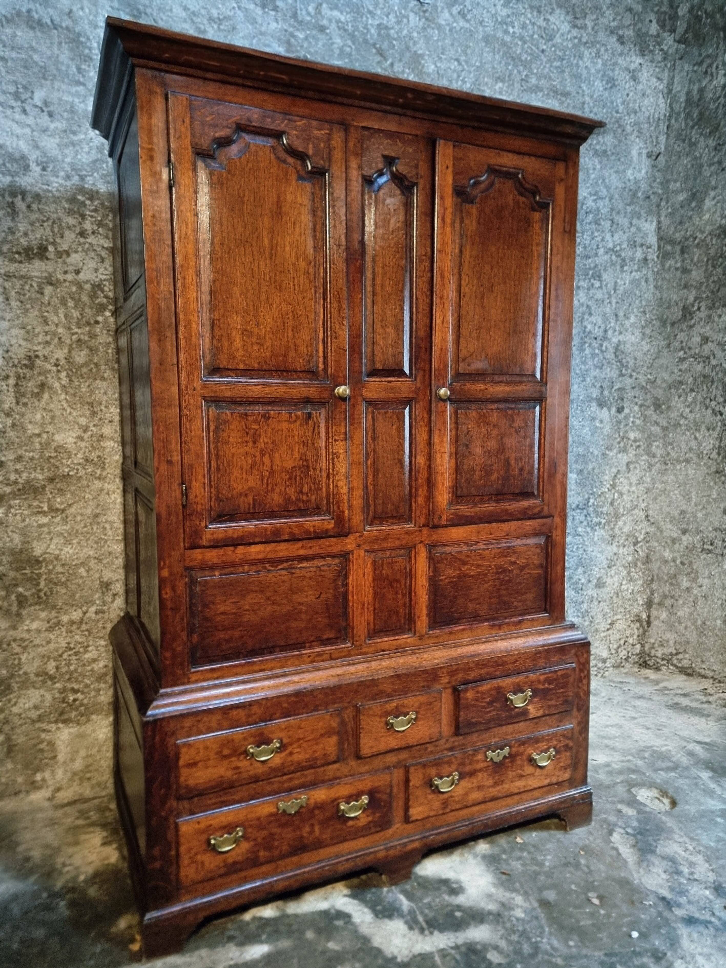 Antique English oak wardrobe with drawers, England, circa 1800–1820.