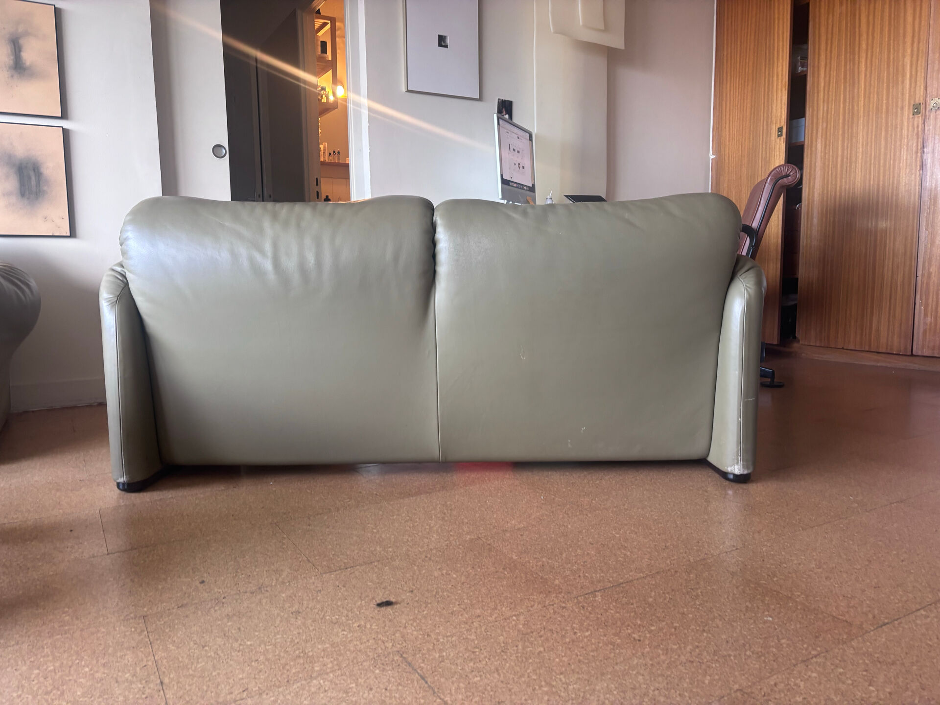 Two-seater Maralunga sofa in olive green leather.