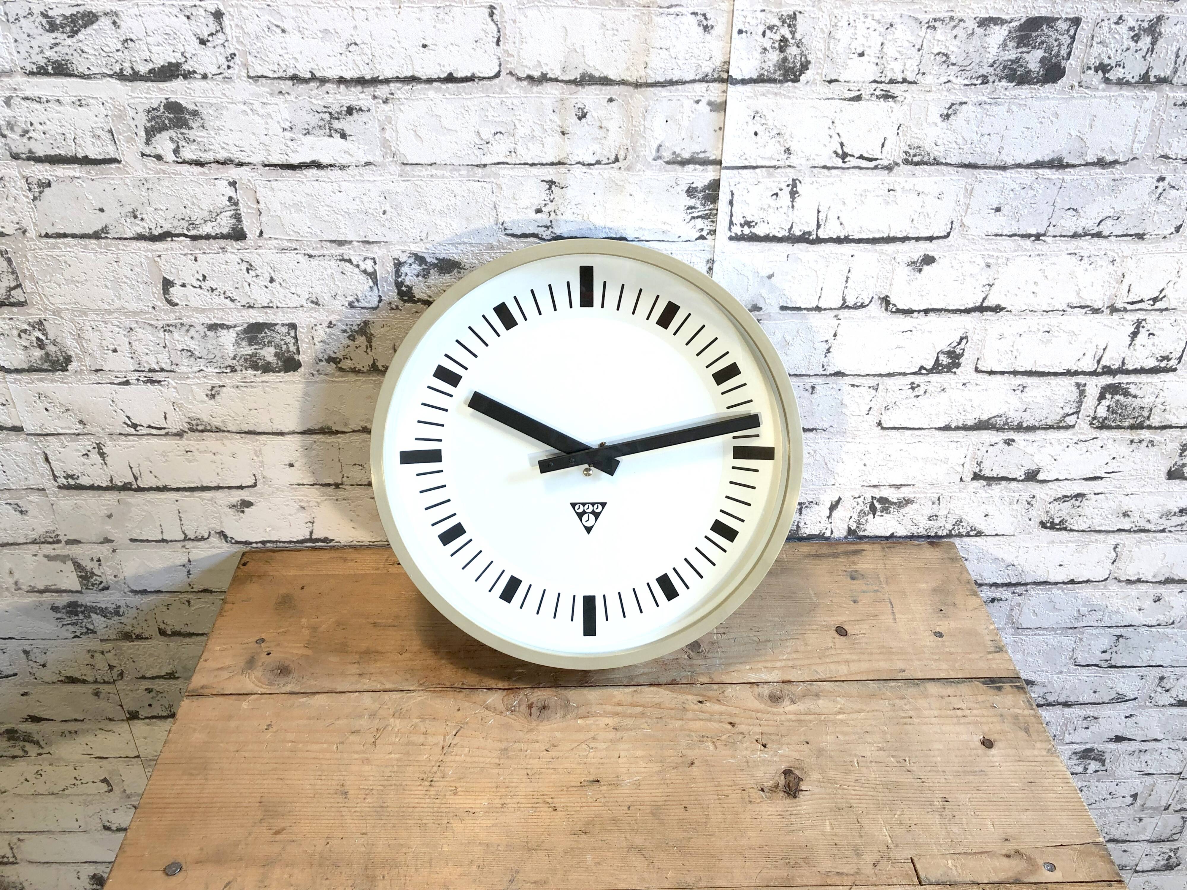 Beige industrial bakelite wall clock from Pragotron, 1970s