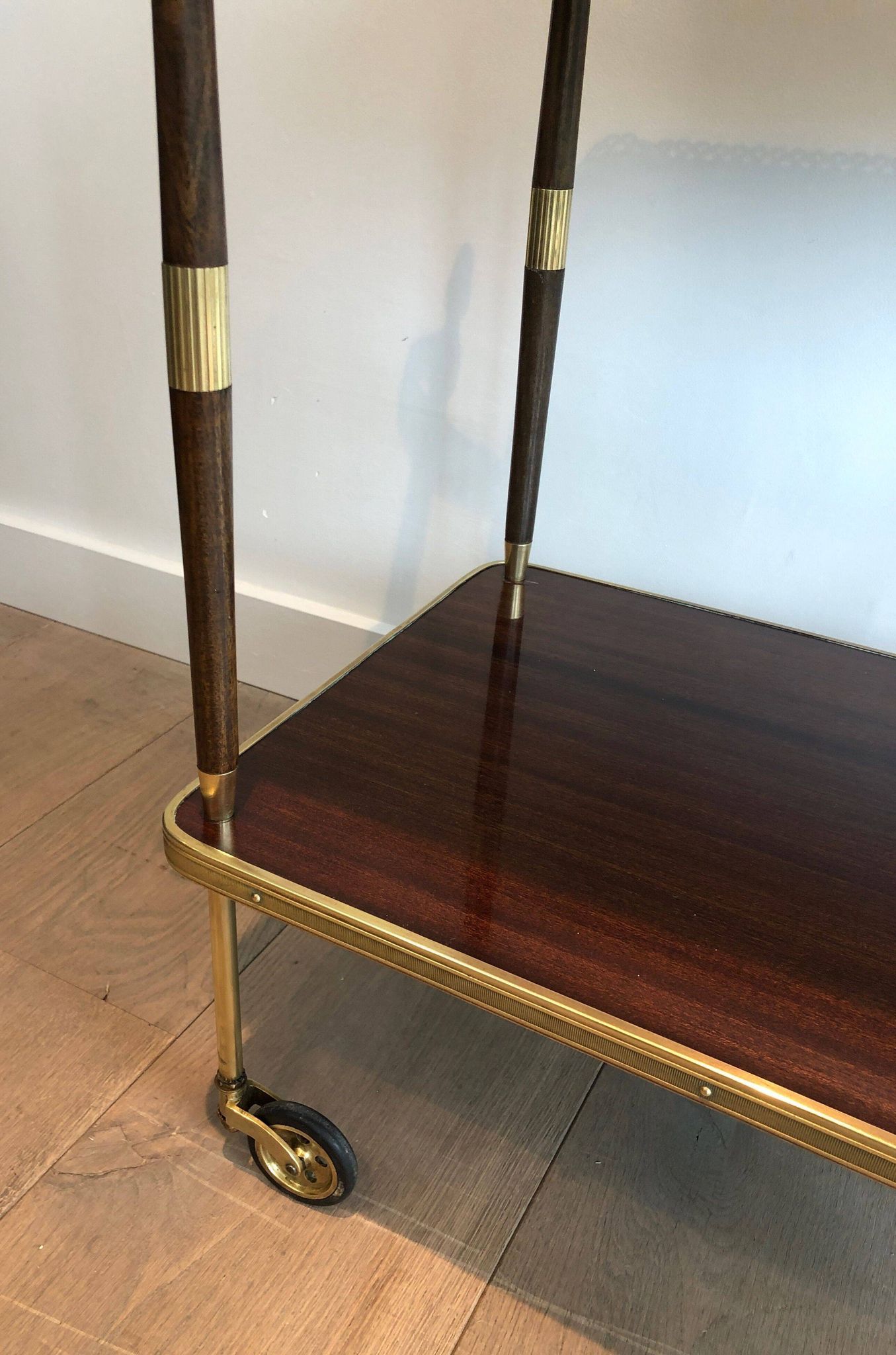 Mahogany and brass rolling table in the style of Maison Jansen.