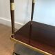 Mahogany and brass rolling table in the style of Maison Jansen.