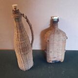 Set of two glass and wicker bottles