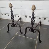 Old pair of wrought iron pegs with brass pine cone