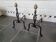 Old pair of wrought iron pegs with brass pine cone