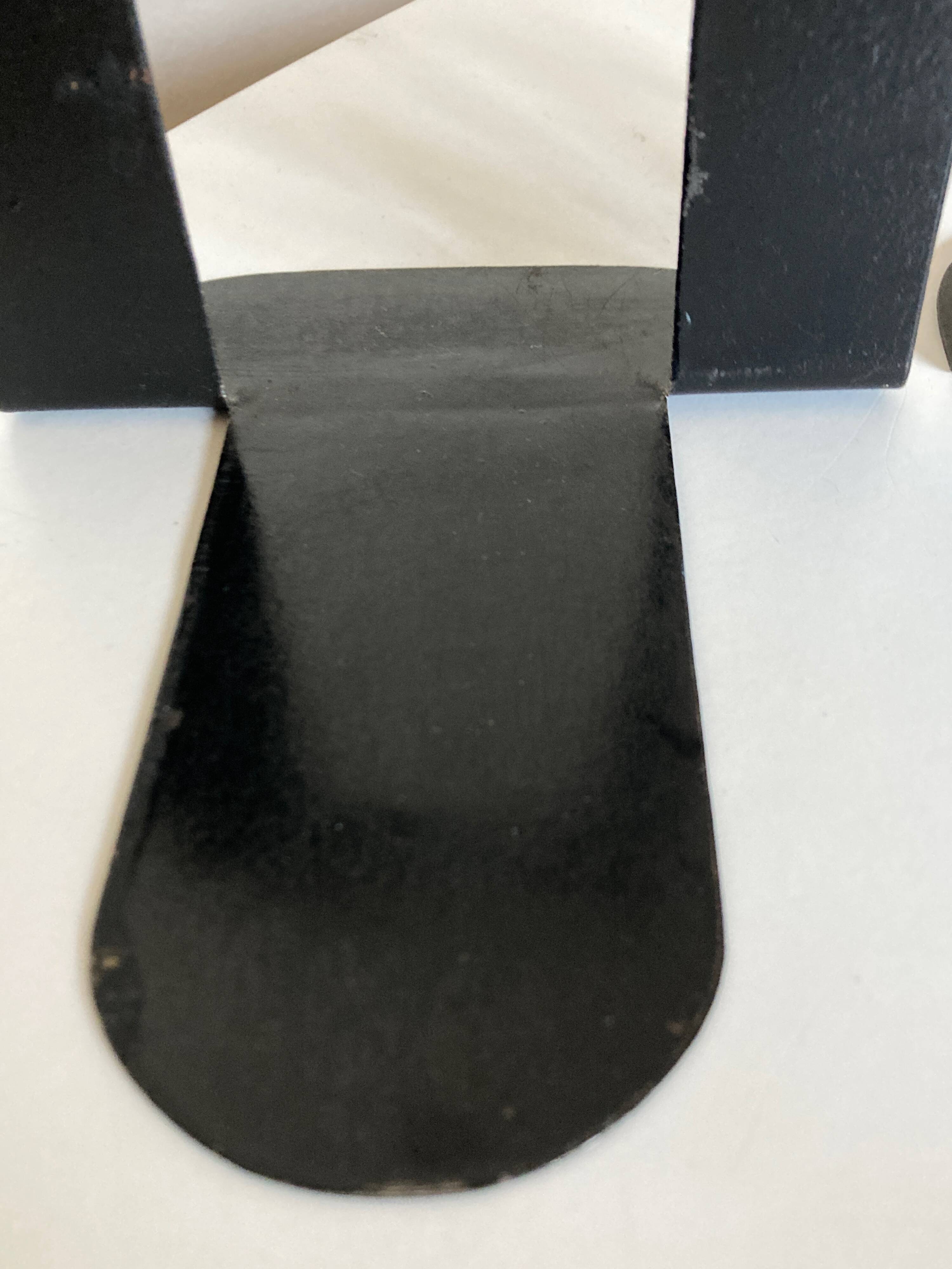 Pair of heavy metal bookends, folded, 1920.