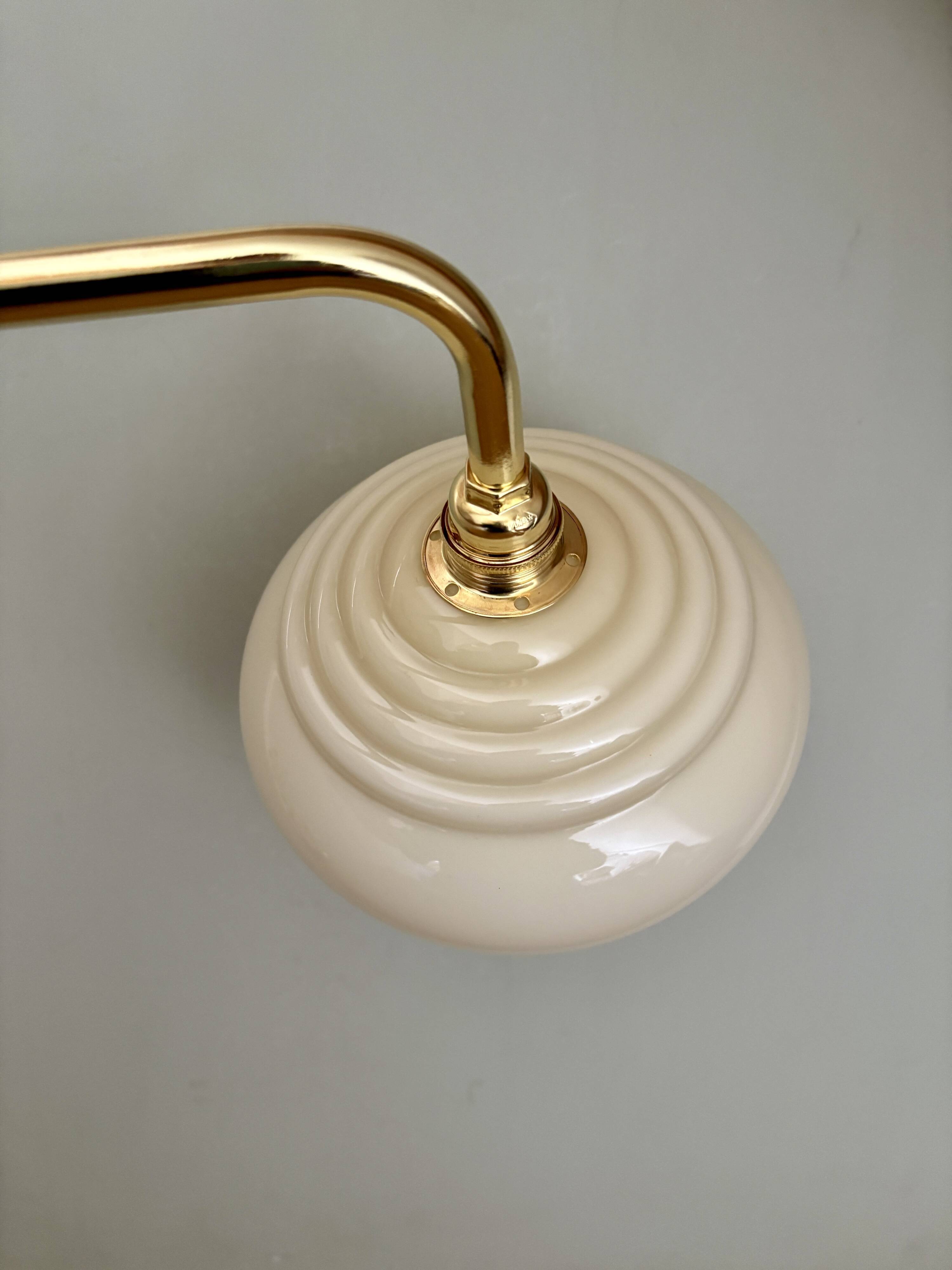 Vintage angled wall lamp with pale yellow opaline shade