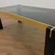 Italian coffee table from the 70s, smoked glass, black and gold lacquered wood.