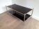 Neoclassical style coffee table in bronze and brass with double black lacquered glass tops from Maison Baguès