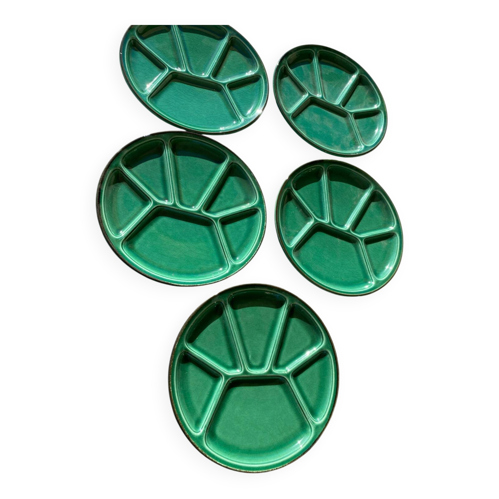 Many glazed stoneware plates with compartments.
