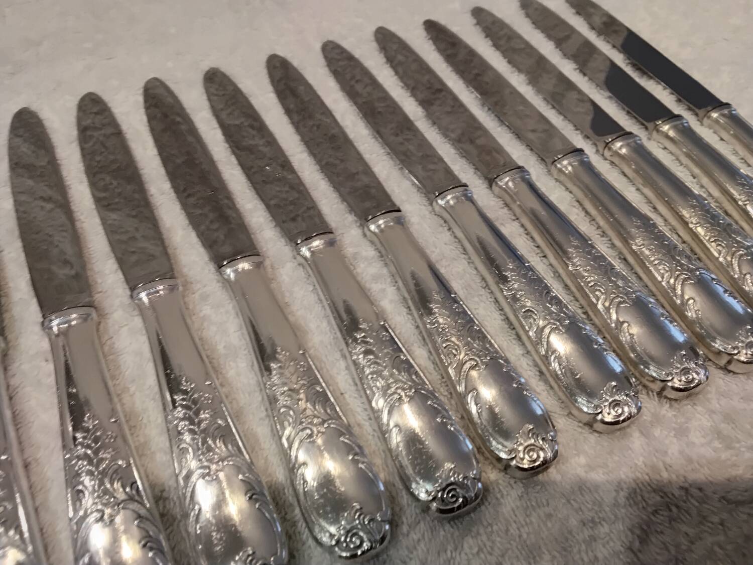12 silver-plated dessert knives by Platil, rocaille style