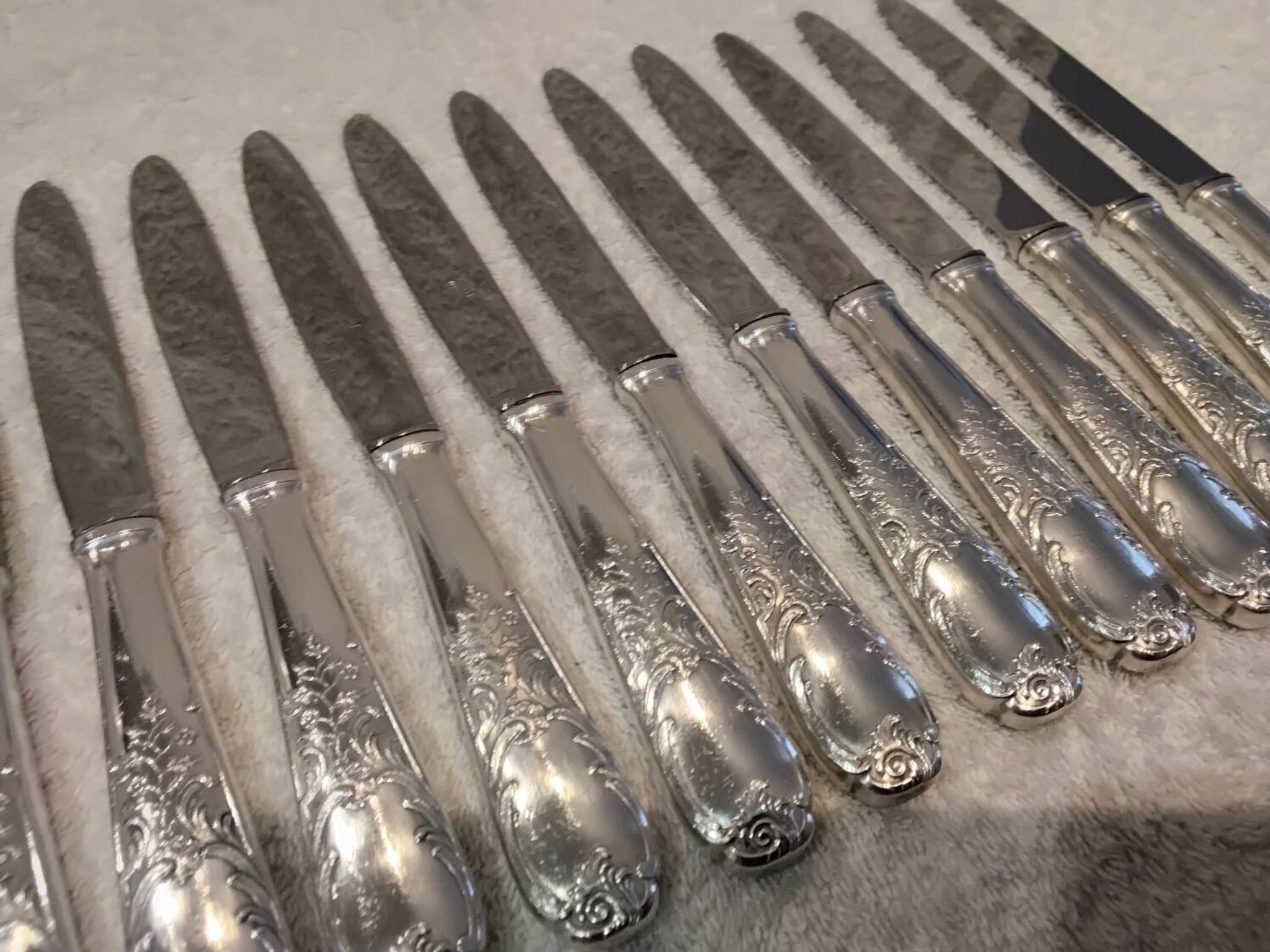 12 silver-plated dessert knives by Platil, rocaille style